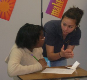 An experienced debater offers advice to a beginner   at DKC school support visit 